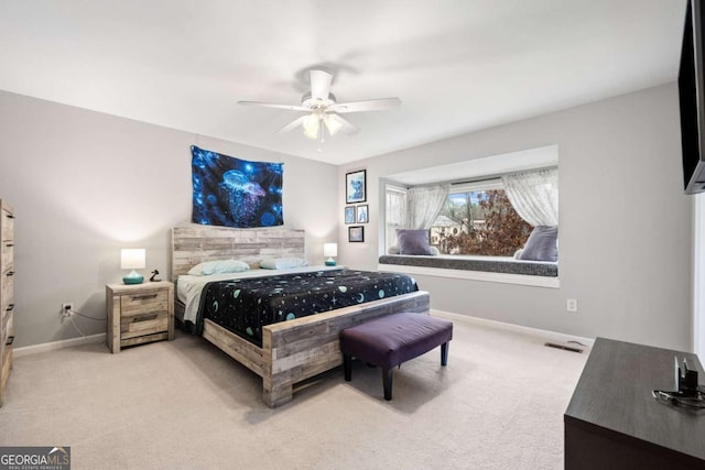 carpeted bedroom with visible vents, ceiling fan, and baseboards