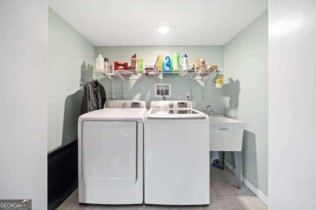 washroom featuring laundry area, light tile patterned flooring, separate washer and dryer, and baseboards