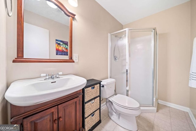 bathroom with toilet, a stall shower, baseboards, vanity, and vaulted ceiling