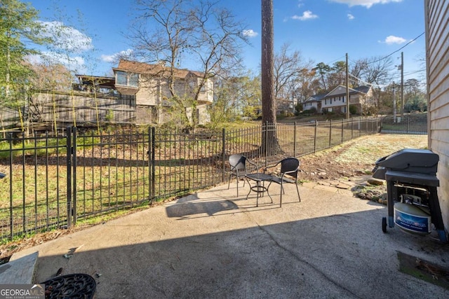 view of patio / terrace featuring a grill and fence