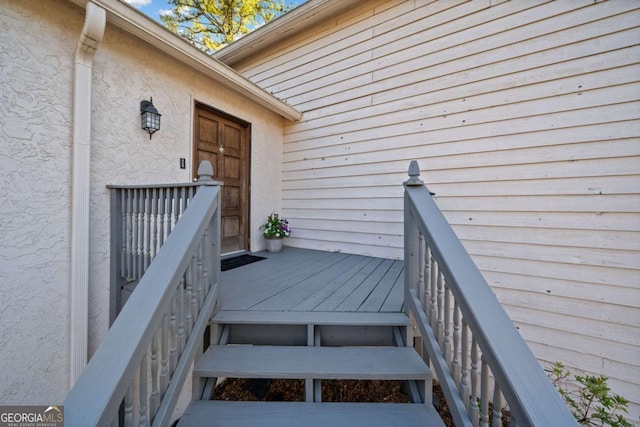 doorway to property featuring stucco siding