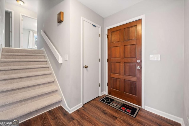 entryway featuring stairway, baseboards, and dark wood finished floors