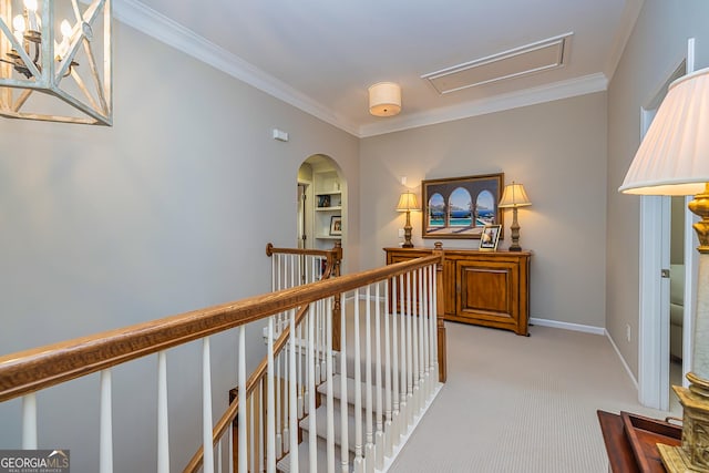 hall with an upstairs landing, arched walkways, light carpet, and crown molding