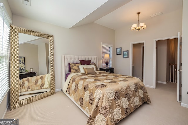 carpeted bedroom featuring vaulted ceiling, a notable chandelier, baseboards, and visible vents