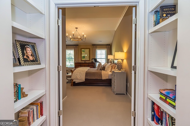 bedroom with an inviting chandelier and carpet