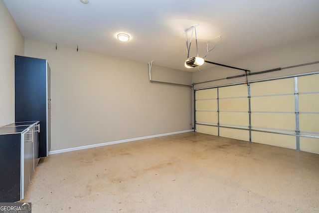 garage with a garage door opener and baseboards