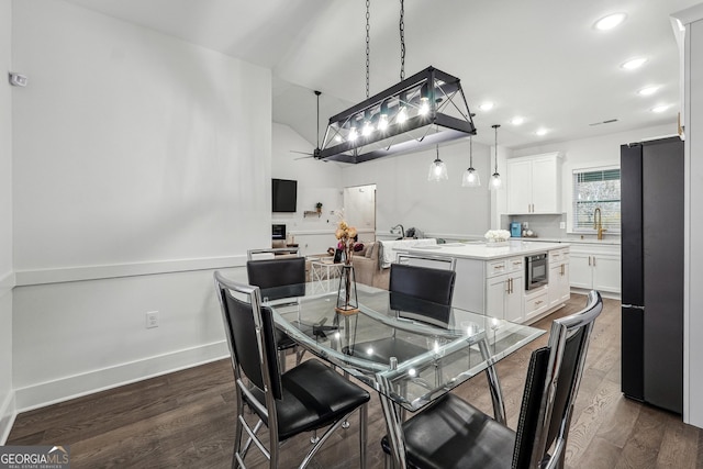 dining area with recessed lighting, baseboards, dark wood finished floors, and vaulted ceiling