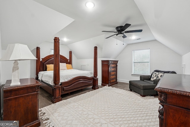 bedroom with a ceiling fan, wood finished floors, visible vents, baseboards, and lofted ceiling