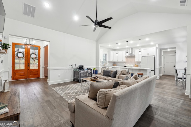 living room featuring visible vents, high vaulted ceiling, and dark wood-style flooring