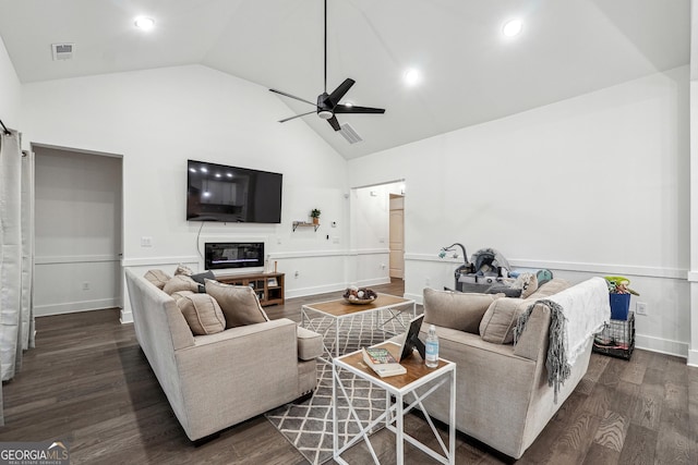 living room featuring a ceiling fan, wood finished floors, visible vents, high vaulted ceiling, and a glass covered fireplace