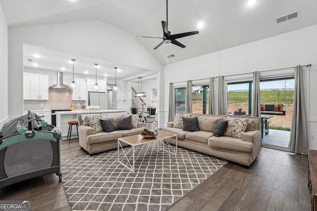 living room with dark wood finished floors, visible vents, high vaulted ceiling, and ceiling fan