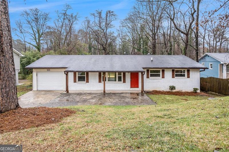 1643 Pine Glen Cir, Decatur, GA 30035 - ranch-style house featuring a front lawn, fence, concrete driveway, a garage, and brick siding