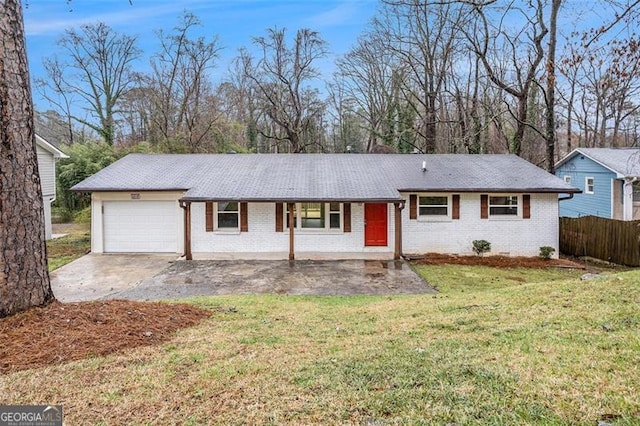 ranch-style house featuring a front lawn, fence, concrete driveway, a garage, and brick siding