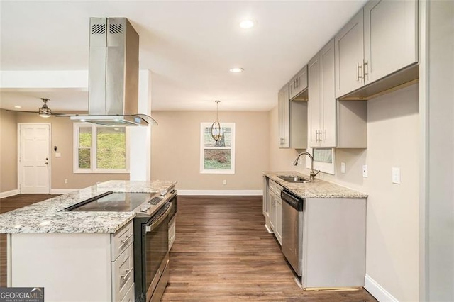 kitchen featuring a sink, appliances with stainless steel finishes, light stone countertops, and island range hood