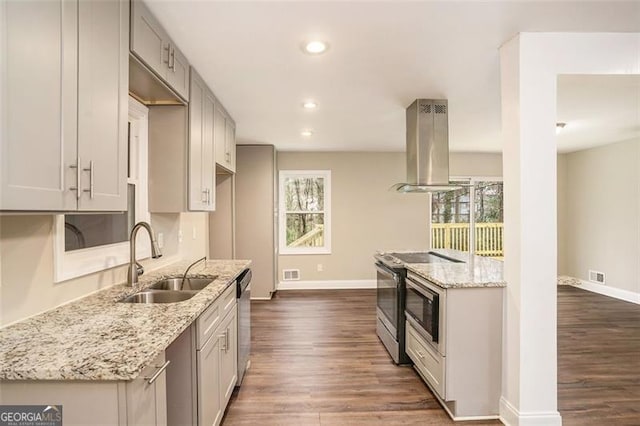 kitchen featuring visible vents, a sink, range with electric cooktop, dishwasher, and island range hood