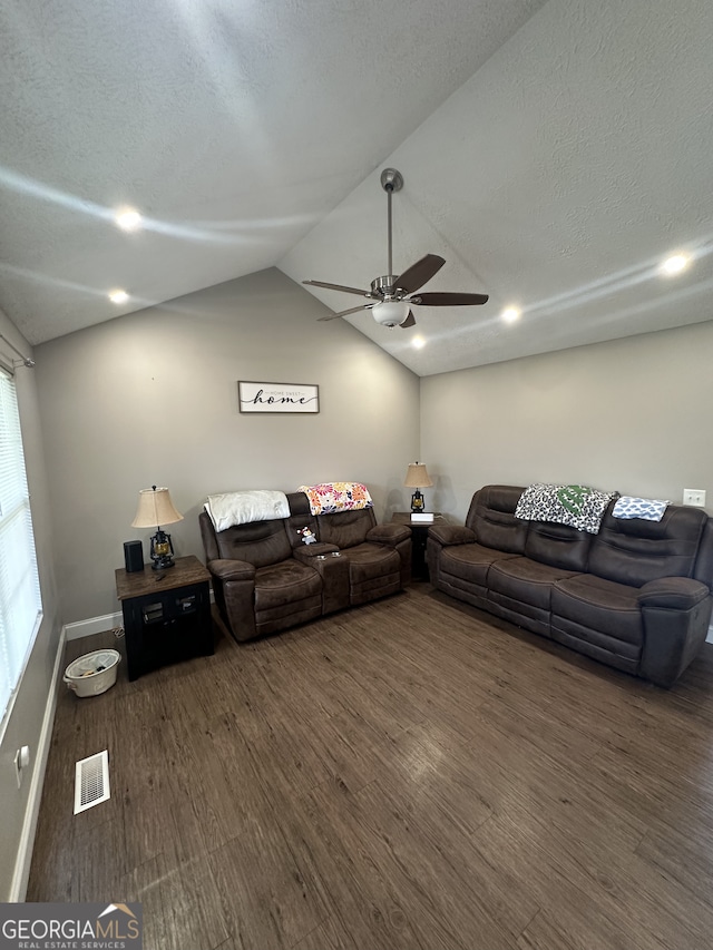 living area featuring visible vents, ceiling fan, lofted ceiling, wood finished floors, and a textured ceiling