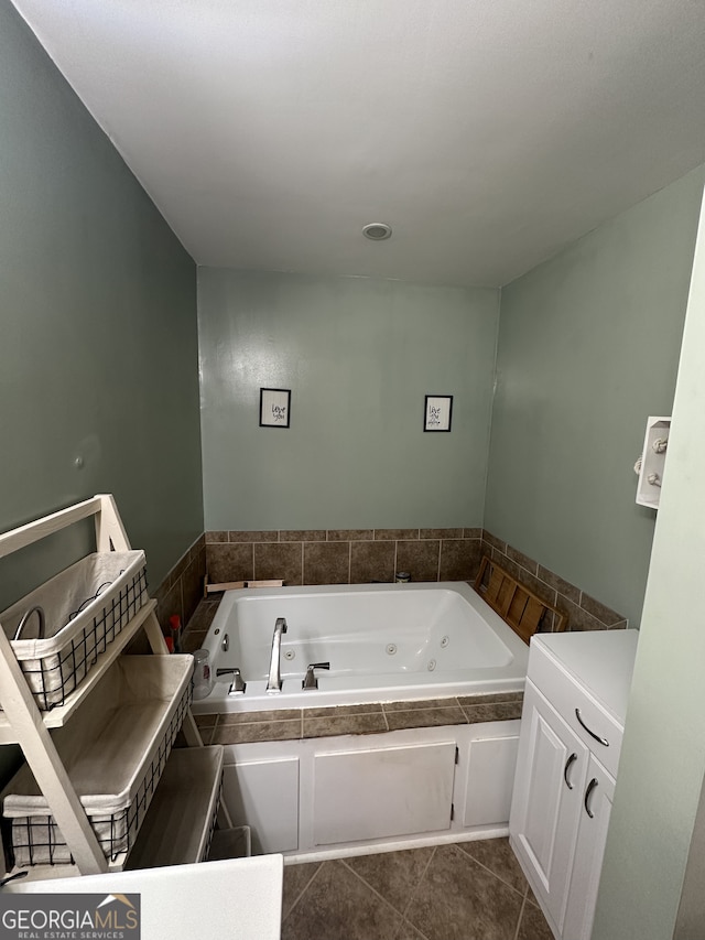 bathroom with tile patterned floors and a tub with jets