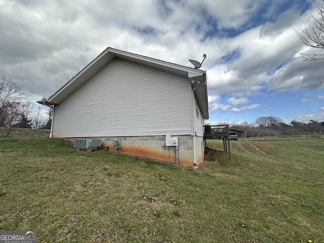 view of property exterior featuring a wooden deck, a lawn, and central AC unit