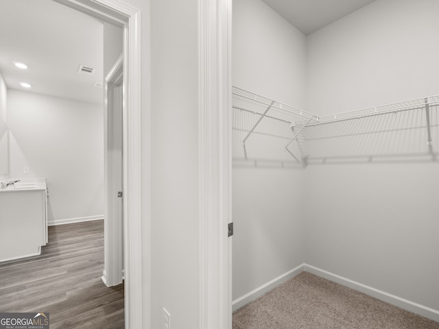 spacious closet with wood finished floors and visible vents