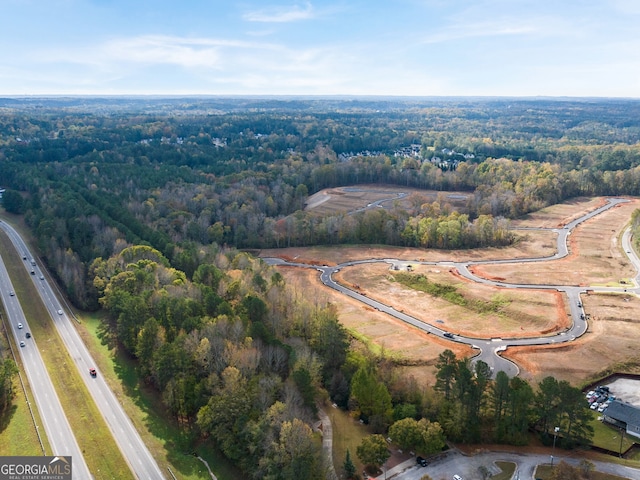 birds eye view of property with a forest view