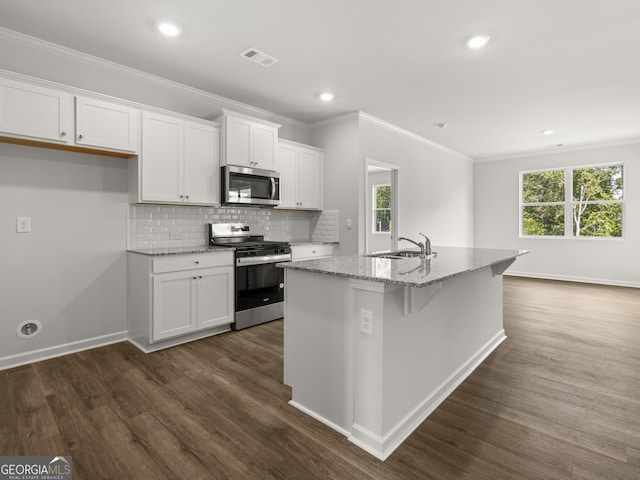 kitchen with visible vents, backsplash, dark wood finished floors, white cabinetry, and stainless steel appliances