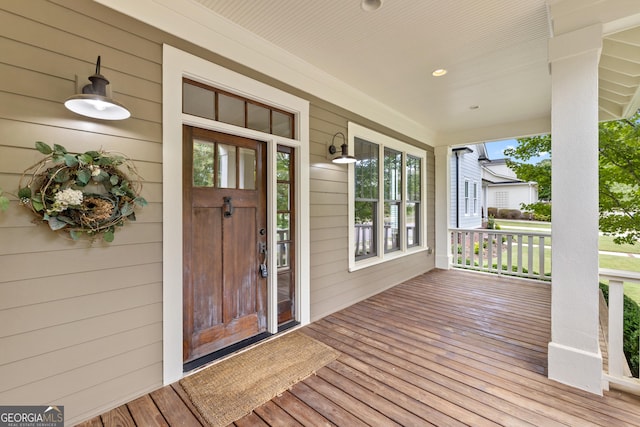 view of exterior entry with a porch