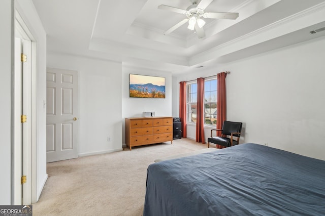 bedroom featuring visible vents, baseboards, a tray ceiling, crown molding, and light colored carpet