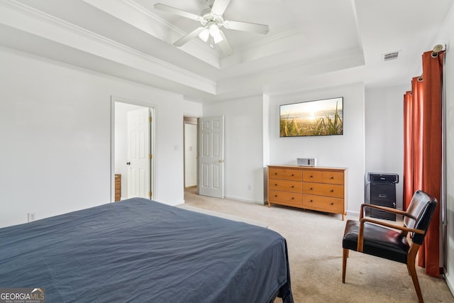 bedroom with baseboards, visible vents, crown molding, a raised ceiling, and light colored carpet