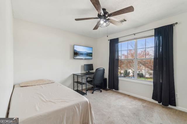 carpeted bedroom featuring visible vents, baseboards, and a ceiling fan