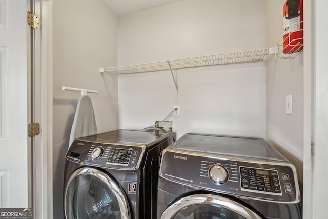 laundry area with laundry area and independent washer and dryer