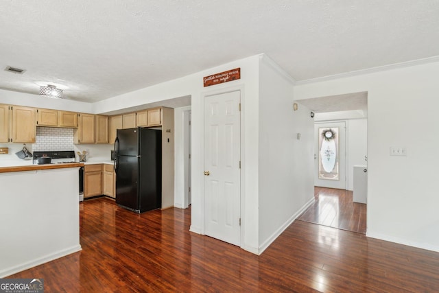 kitchen with range with electric cooktop, tasteful backsplash, freestanding refrigerator, light countertops, and dark wood-style flooring