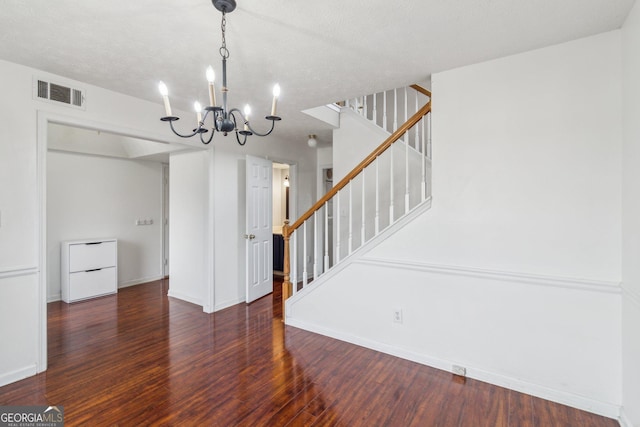 interior space with visible vents, wood finished floors, stairway, baseboards, and a chandelier