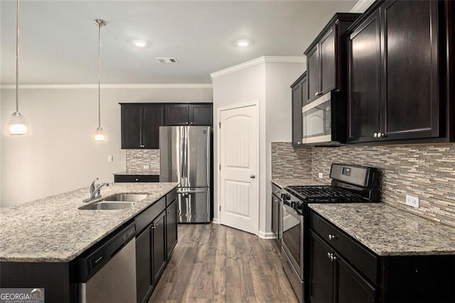 kitchen with visible vents, a sink, light stone counters, stainless steel appliances, and dark wood-style flooring