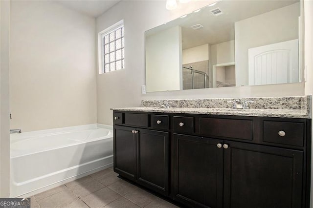 full bath with a garden tub, visible vents, a stall shower, a sink, and tile patterned floors