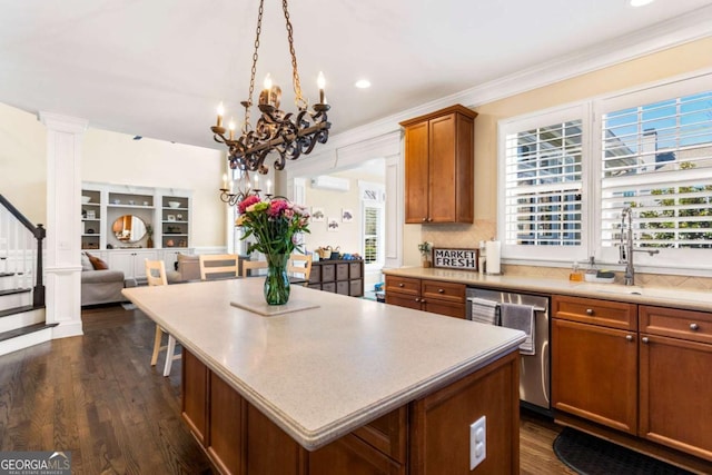 kitchen with a center island, an AC wall unit, brown cabinets, dark wood-style floors, and stainless steel dishwasher