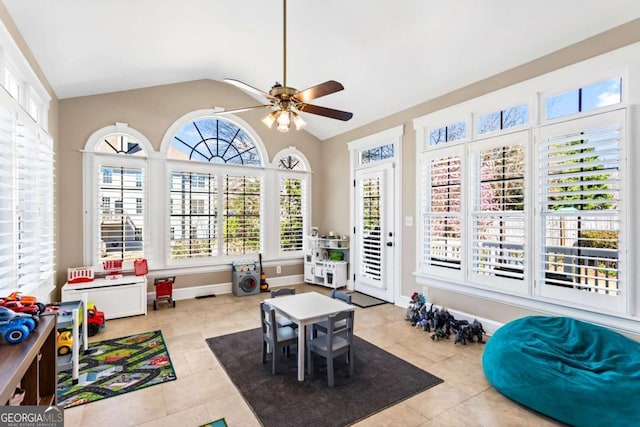 sunroom / solarium featuring lofted ceiling and ceiling fan