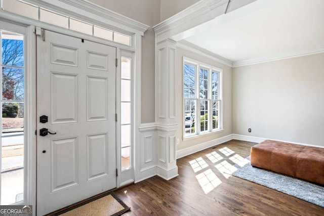 entryway with dark wood-style floors, baseboards, ornate columns, and ornamental molding