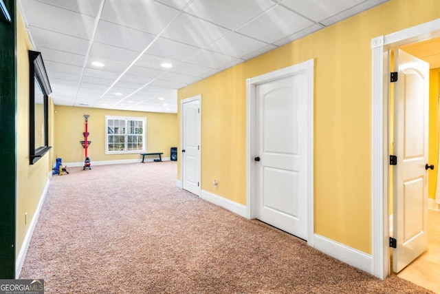 interior space featuring recessed lighting, carpet, baseboards, and a drop ceiling