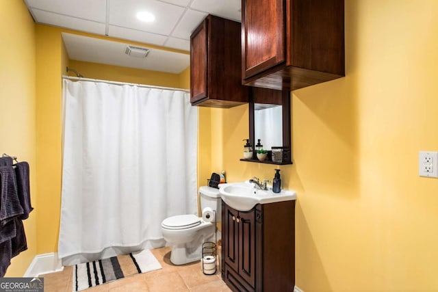 full bathroom with vanity, visible vents, a drop ceiling, tile patterned flooring, and toilet