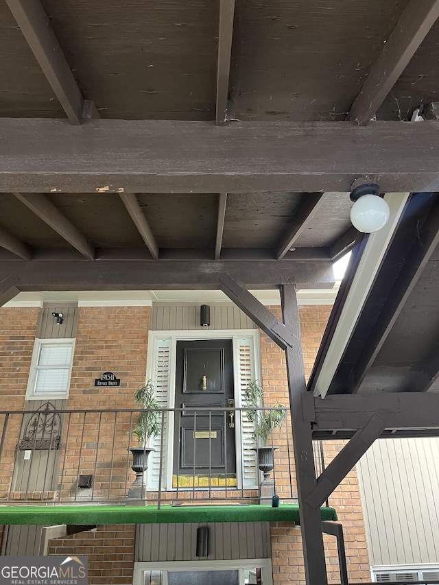 property entrance with brick siding