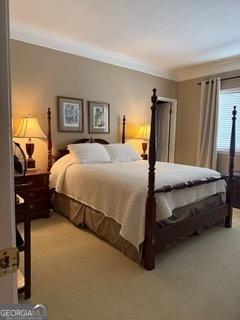 bedroom featuring light carpet and crown molding