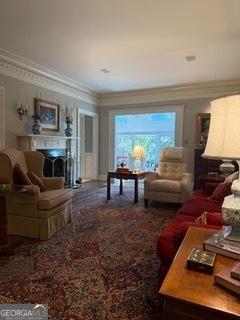 carpeted living area featuring a fireplace and ornamental molding