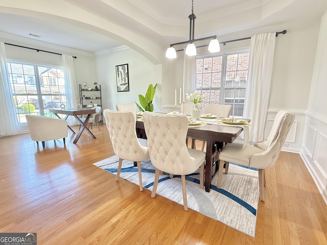 kitchen featuring light wood-type flooring, appliances with stainless steel finishes, brown cabinetry, and light countertops