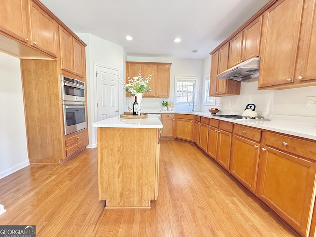 unfurnished living room with baseboards, visible vents, light wood finished floors, a fireplace with flush hearth, and ceiling fan