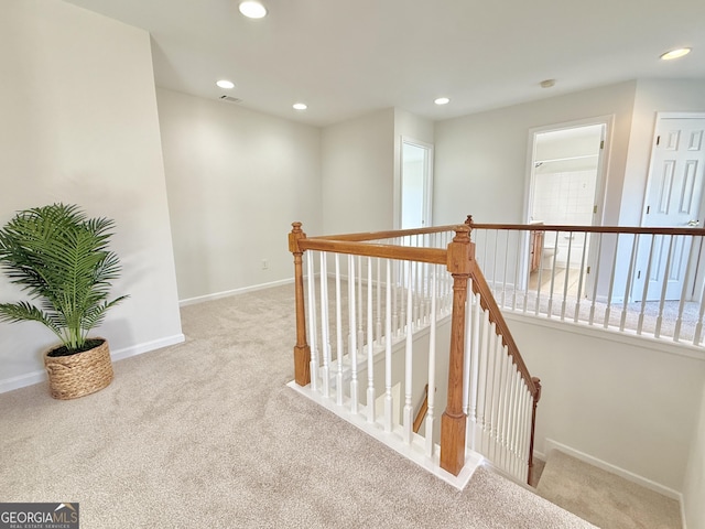 carpeted empty room featuring visible vents, baseboards, a tray ceiling, arched walkways, and ornamental molding