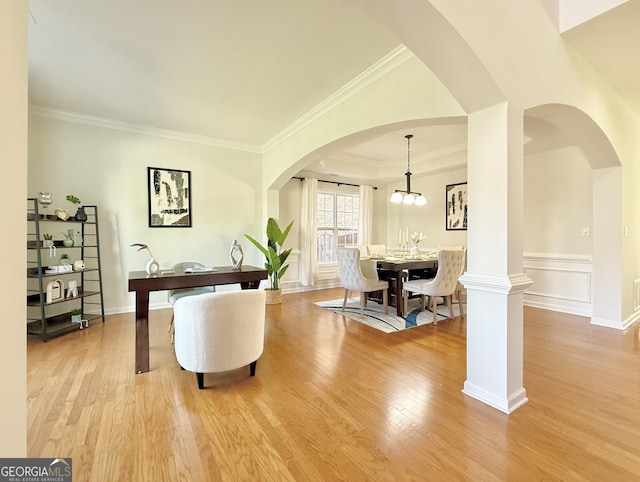 interior space featuring arched walkways, wood finished floors, and crown molding