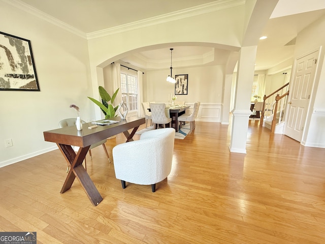 unfurnished dining area with a tray ceiling, a decorative wall, wood finished floors, and stairway