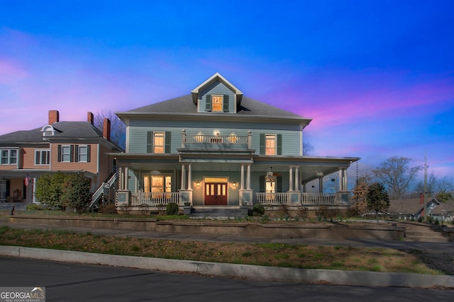 view of front of house featuring covered porch and a balcony