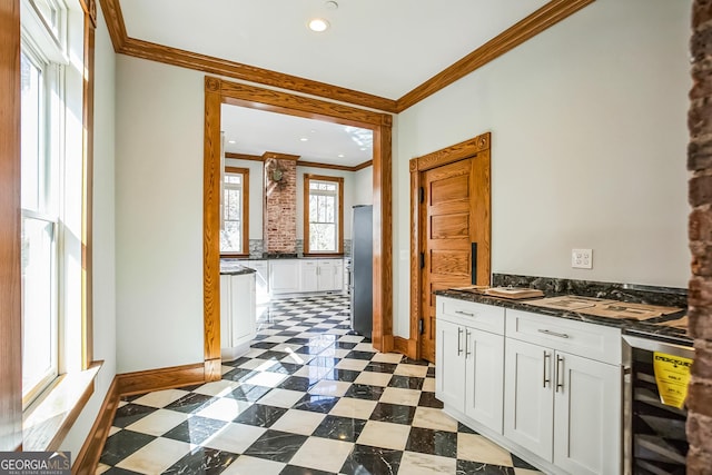 kitchen with beverage cooler, freestanding refrigerator, ornamental molding, dark countertops, and dark floors