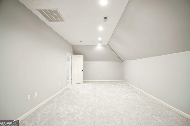 bonus room featuring lofted ceiling, baseboards, visible vents, and light carpet